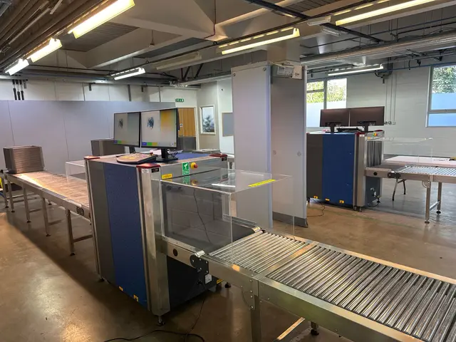 Security checkpoint with two X-ray machines and a walk-through metal detector supplied by RedteQ