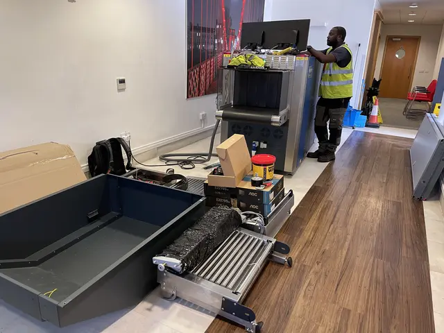RedteQ engineer installing an X-ray machine in an office reception