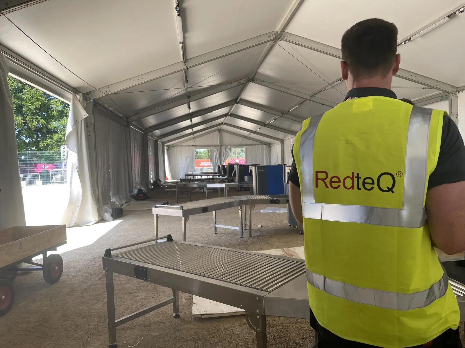 RedteQ engineer in branded hi-vis at an event installation