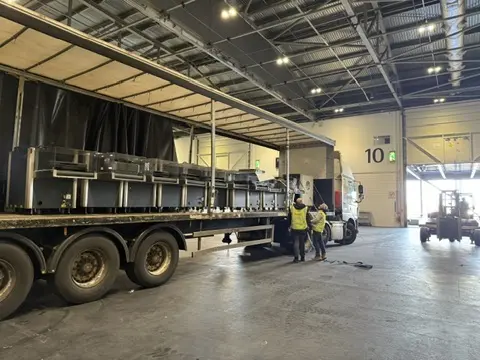 Articulated lorry unloading screening equipment at a venue