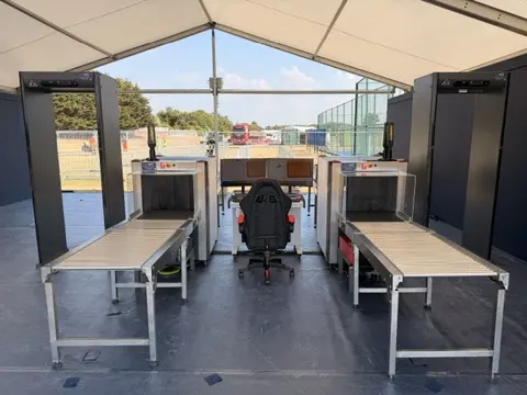 Two X-ray lanes overseen by a single operator using AI detection at a golf tournament