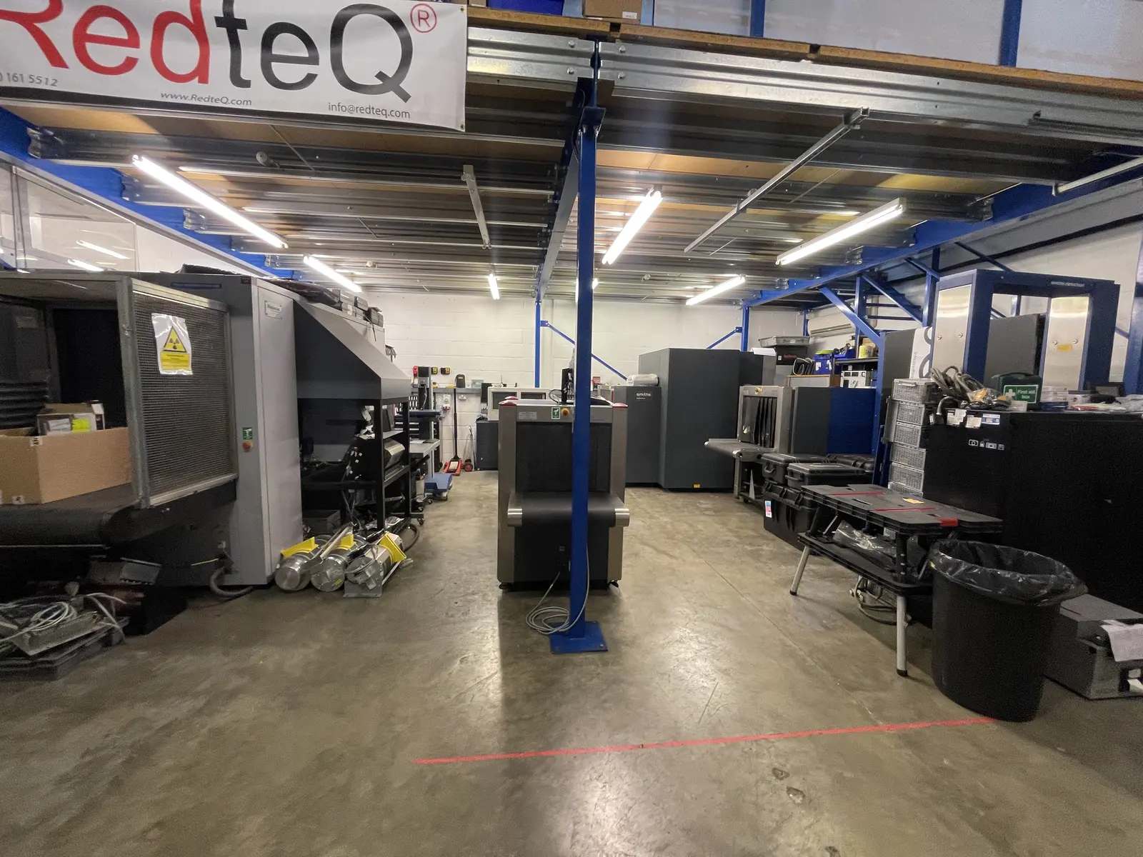 RedteQ workshop floor with screening equipment and branded signage